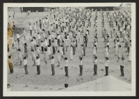 [recto] View of the 5th and 6th graders going through their exegeses on elementary school grounds. ;  Photographer: Okano, Tom K. ;  Dermott, Arkansas.
