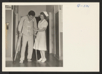 [recto] Pfc. Kiyashi Yonemori tries taking a few steps with the help of crutches and the nurse. While Yonemori was serving ...