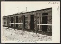 [recto] Near view of horse-stall, left from the days when what is now Tanforan Assembly Center was the famous Tanforan Race Track. Most of these stalls have been converted into family living quarters for Japanese. ;  Photographer: Lange, Dorothea ;  San Bruno