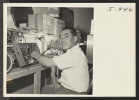 [recto] Mr. George M. Takeuchi is busily at his work repairing radios at his Radio Parts and Repair shop located at ...