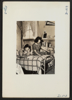 [recto] Manzanar, Calif.--Oko Murata (left), and Esther Naito, office workers from Los Angeles, in their quarters at Manzanar, a War Relocation ...