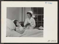 [recto] Miss Masako Takayoshi attending a patient in the Colorado General Hospital, where she is employed as assistant head nurse in ...