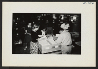 [recto] Left to right are Masako Mikami, Miss Gladys Townsend, Chiyoka Kawanami, George Nakaji, Aiko Nishikata of the Jerome Office Services Section assembling the files for persons being transferred to Tule Lake. ;  Photographer: Lynn, Charles R. ;  Dermott,