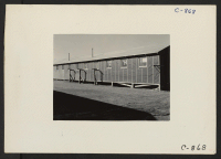 [recto] Manzanar, Calif.--View of side barrack building at this War Relocation Authority center for evacuees of Japanese ancestry. ;  Photographer: Lange, Dorothea ;  Manzanar, California.
