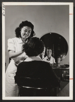 [recto] Miss Ann Tanaka owns and operates her own beauty shop on upper Broadway in New York. Ann relocated from the ...