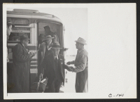 [recto] San Bruno, Calif.--Evacuees of Japanese ancestry arriving at the Tanforan Assembly Center. They are being checked as they leave the bus. ;  Photographer: Lange, Dorothea ;  San Bruno, California.