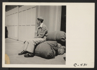 [recto] San Francisco, Calif. (2020 Van Ness Ave.)--Young high school boy of Japanese ancestry at WCCA station awaiting evacuation bus. He is a member of the first contingent of over 600 persons to be evacuated from San Francisco. ;  Photographer: Lange, Doroth