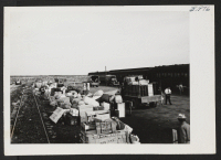 [recto] Baggage of Tule Lake transferees sorted and piled accordingly at Hunt siding. Most of the baggage was delivered to the owners the same day. ;  Hunt, Idaho.