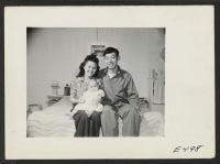 [recto] A young nisei family, Howard Uno, his wife and baby. Howard, a former Los Angeles vegetable producer, has volunteered in the United States Army and is now stationed at Camp Savage, Minnesota. ;  Photographer: Parker, Tom ;  Amache, Colorado.
