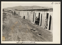 [recto] This center is a converted race track. Here are shown what were horse-stalls, now remodeled into living quarters for families. Photograph was made at noon on the third day after the center had been opened. ;  Photographer: Lange, Dorothea ;  San Bruno