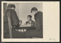 [recto] Masao Igasaki, instructor, listens carefully to check the inflection of tone and pronunciation while lunching with students at the University ...
