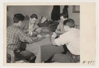 [recto] The evacuee firemen spend their recreation moments, as do all firemen, by playing a good old American game of cards. ;  Photographer: Stewart, Francis ;  Newell, California.