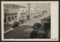 [recto] San Pedro, Calif.--View of main street at Terminal Island in Los Angeles Harbor, California. All residents of Japanese descent were evacuated from this area, and will be housed in War Relocation Authority centers for the duration. ;  Photographer: Alber