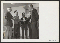 [recto] Center Director Ray Johnston, right, congratulates George Kiwashima on his voluntary enlistment in the United States Army while Captain John ...