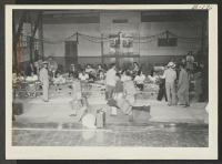 [recto] Registration table for new arrivals from Tule Lake. ;  Photographer: McClelland, Joe ;  Amache, Colorado.