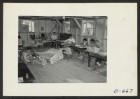 [recto] A general view of the Community Activities Office. Here evacuees are preparing for the Harvest Festival to be held November 26, 1942--Thanksgiving day. ;  Photographer: Stewart, Francis ;  Rivers, Arizona.