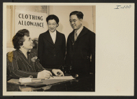 [recto] Virgil Payne, head of the Social Welfare Department, is helping Mr. and Mrs. Thomas T. Sashihara make application for clothing ...