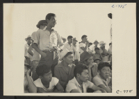 [recto] Manzanar, Calif.--Evacuees of Japanese ancestry are enjoying a baseball game at this War Relocation Authority center. 80 teams have been organized to date. Most of the playing is in the wide fire-break between blocks of barracks. ;  Photographer: Lange,