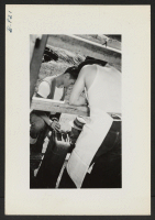 [recto] Jerome evacuees supplied the gasoline to segregation kitchen cars. ;  Photographer: Lynn, Charles R. ;  Dermott, Arkansas.