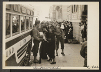 [recto] Friends and neighbors congregate to bid farewell, though not for long, to their friends who are enroute to the Tanforan Assembly Center. They, themselves, will be evacuated within three days. ;  Photographer: Lange, Dorothea ;  San Francisco, Californ