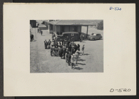 [recto] Manzanar, Calif.--Evacuees of Japanese ancestry await bus for Manzanar, War Relocation Authority center, where they will spend the duration. They were brought by train to Lone Pine from Elk Grove, California. ;  Photographer: Stewart, Francis ;  Manza