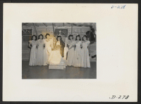 [recto] The Labor Day queen is shown with her maids of honor at the coronation ceremony which was held as a part of the celebration held at this relocation center. ;  Photographer: Stewart, Francis ;  Newell, California.