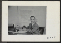 [recto] Paul A. Taylor, Project Director of this Relocation Center, seated at his desk. ;  Photographer: Parker, Tom ;  Denson, Arkansas.