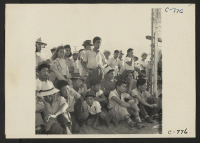 [recto] Manzanar, Calif.--Evacuees of Japanese ancestry enjoying a baseball game at this War Relocation Authority center. 80 teams have been organized to date with most of the playing being done in the wide fire-break between blocks of barracks. ;  Photographer
