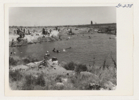 [recto] Swimming hole located south of warehouse are adjacent to the North Side Irrigation Canal, which may be seen at upper right. Water flows from canal into pool and out again. The average depth of pool is 6 feet. ;  Hunt, Idaho.