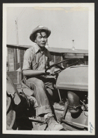 [recto] Close up of tractor and driver. ;  Photographer: Cook, John D. ;  Newell, California.