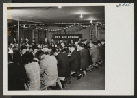 [recto] Scene at the welcome banquet held in honor of Sgt. Kuroki at mess hall 14-27. ;  Photographer: Aoyama, Bud ;  Heart Mountain, Wyoming.