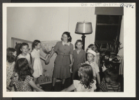 [recto] Games with Chico Sakaguchi, a staff member of the Hope Day Nursery, are eagerly awaited by the children. Chico, who relocated from Manzanar in April, 1944, is a skilled social worker, and the children and their parents deeply appreciate her excellent work