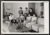 [recto] A small group of the many Japanese American girls employed as maids in the Stevens Hotel in Chicago are relaxing ...