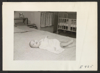 [recto] The young son of Howard and Mrs. Uno. On the day this picture was made, his father, Howard Uno, enlisted in the U.S. Army. ;  Photographer: Parker, Tom ;  Amache, Colorado.