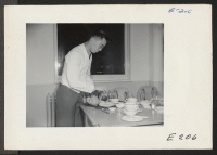 [recto] John Shiokari, a freshman at the Agricultural Engineering School, who is working in the Y.M.C.A. cafeteria for his room and board. ;  Photographer: Parker, Tom ;  Lincoln, Nebraska.