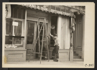 [recto] San Francisco, Calif. (Post Street). Owners of Japanese ancestry board windows of their stores prior to evacuation. Evacuees will be housed in War Relocation Authority centers for the duration. ;  Photographer: Lange, Dorothea ;  San Francisco, Califo