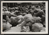 [recto] Baggage belonging to evacuees of Japanese ancestry at assembly center prior to transfer to a War Relocation Authority center. ;  Photographer: Albers, Clem ;  Salinas, California.