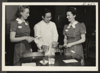 [recto] Miss Esther Mart, Mr. Frank Inouye and Miss Maxine Cox are at work in the Fort Des Moines Hotel Coffee ...