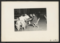 [recto] A family gives pre-evacuation data at Wartime Civil Control Administration station. Evacuees of Japanese ancestry will be housed in War Relocation Authority centers for the duration. ;  Photographer: Lange, Dorothea ;  Lodi, California.