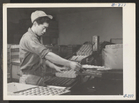 [recto] Ralph Iyemure, formerly a nursery man in Oakland, California, is shown here operating an egg sealing machine at Toner's Egg ...
