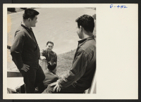 [recto] Three members of the 100th Battalion, all wounded in Italy and recovering at the Moore General Hospital, Swannanoa, North Carolina, talking with 1st Lt. Shigeru Tsubota. ;  Photographer: Van Tassel, Gretchen ;  Swannanoa, North Carolina.