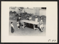 [recto] Arcadia, Calif.--A ping pong game on a home-made table occupies the attention of these young evacuees of Japanese descent at Santa Anita Assembly center. ;  Photographer: Albers, Clem ;  Arcadia, California.