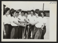 [recto] Manzanar, Calif.--Members of the Chick-a-dee soft ball team from Los Angeles choose sides for a practice game at Manzanar, where, ...