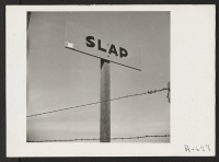 [recto] Slap the Jap with Iron Scrap Burma Shave sign on highway. The population of this farming area was made up largely of people of Japanese ancestry prior to evacuation. Resentment of them is now widespread. ;  Photographer: Stewart, Francis ;  Loomis, Ca