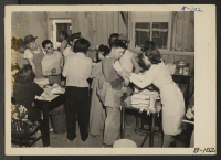 [recto] Manzanar, Calif.--Newcomers are vaccinated by evacuees of Japanese ancestry on arrival at this War Relocation Authority center. ;  Photographer: Albers, Clem ;  Manzanar, California.