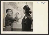 [recto] 1st Lt. Shigeru Tsubota points out where he was serving in Italy with the 100th Battalion to a WAC corporal. Lt. Tsubota is at the Moore General Hospital recovering from a leg wound received in action overseas. ;  Photographer: Van Tassel, Gretchen ;