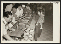 [recto] Cafeteria-style assures promptness in serving meals at Santa Anita Park assembly center for evacuees of Japanese ancestry. Evacuees are transferred later to War Relocation Authority centers for the duration. ;  Photographer: Albers, Clem ;  Arcadia, C