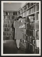[recto] Miss Irene Eiko Yonemura works in the Peoria, Illinois, public library, where she has found work much to her liking and her training. Miss Yonemura is from the Poston center and came to Peoria in the summer of 1943. ;  Photographer: Mace, Charles E.