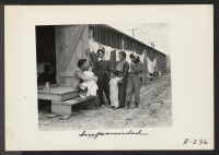 [recto] Persons of Japanese ancestry at the Salinas Assembly Center, where they lived temporarily before being transferred to relocation centers. ;  Photographer: Albers, Clem ;  Salinas, California.