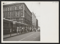 [recto] Street cars taking on passengers on Washington Street in the heart of downtown Indianapolis. In the background is the Claypool Hotel, the management of which has filed a request for help recruited from the centers. ;  Photographer: Mace, Charles E. ;